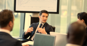 CEO in a meeting with the board talking about metrics